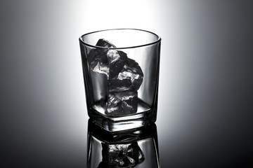 Single glass with ice cubes