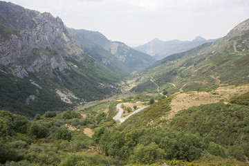 Fototapeta na wymiar Mountain road in Saliencia Valley, Somiedo Nature Reserve. It is located in the central area of the Cantabrian Mountains in the Principality of Asturias in northern Spain