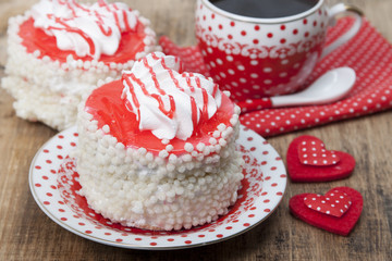 Cake, Red cup of coffee and heart symbol on a table.