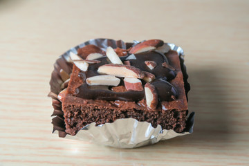 almond chocolate brownies stacked on the wooden