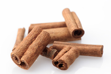 pens cinnamon sticks on white background