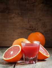Juice of red Sicilian oranges in a large glass, selective focus