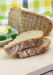 Slices of traditional rustic rye bread on wooden board
