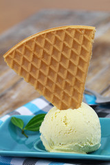 Scoop of vanilla ice cream with sweet wafer
