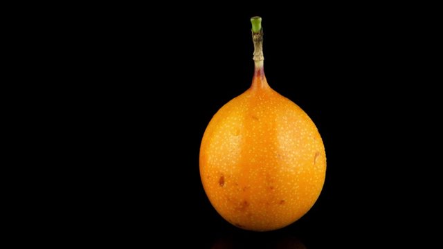 Passion fruit maracuja granadilla on black background.