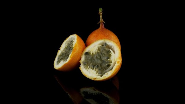 Passion fruit maracuja granadilla on black background.