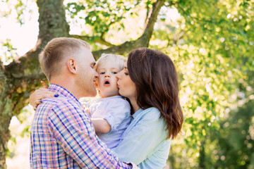 Happy family hugging in a park