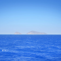 Clear and peaceful sea in Greece with islands on background.