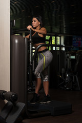 Latina Woman Doing Exercise For Legs On Machine