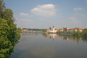 Fototapeta premium PRAGUE, CZECH REPUBLIC - APRIL 28, 2010: Vltava river with Charles bridge crossing the river, museum of Bedrich Smetana and Old Town Water Tower in the background