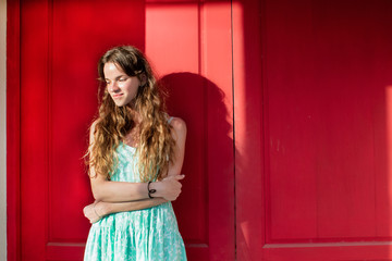 Obraz premium the girl on a red background in a green dress
