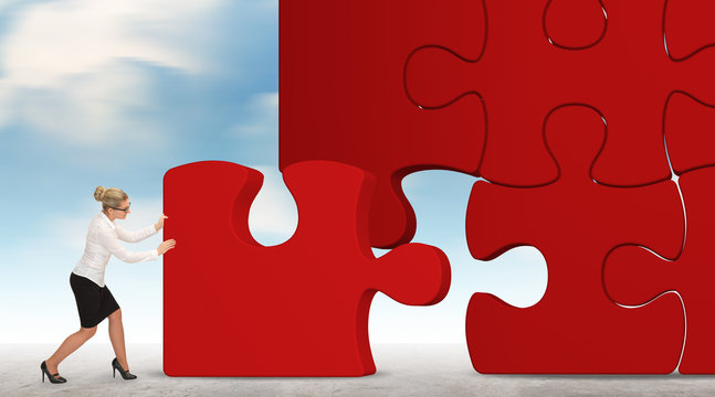 business woman building a red puzzle on a sky background
