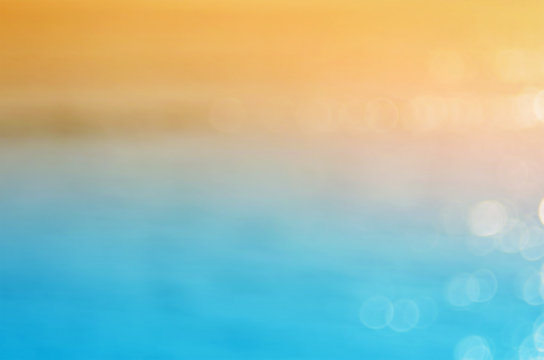 Blur wave beach with bokeh sun light abstract background.