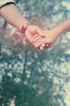 Couple hand holding.