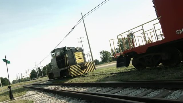 Diesel locomotive links up a caboose on a railway line in the Mid West, USA. Wide view, canted, in ultra high definition, 4K.