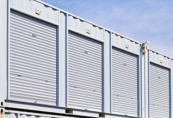 Fototapeta na wymiar Exterior of white storage unit or small warehouse for rental