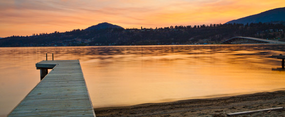 Scenic Mountain Sunrise and Jetty on Still Lake