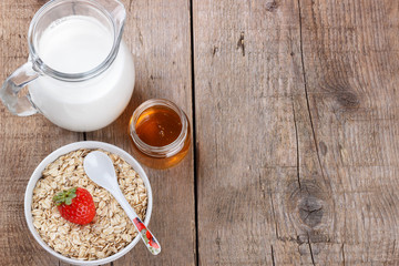Healthy cereal with milk, honey and strawberry