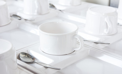 many rows of coffee or tea cups for background.