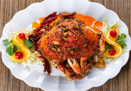 Whole cooked Dungeness crab with peanut sauce and spices 
