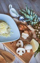 Ingredients for making pasta and pizza. Mushrooms, meat, pineapp
