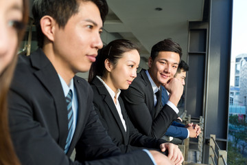 Business people standing outside office