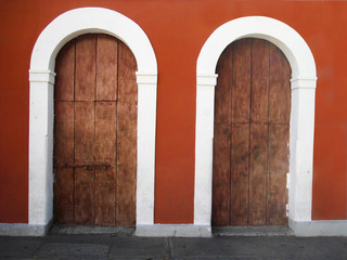 Beautiful old wooden colonial door surrounded by arch. Caracas, Venezuela.
