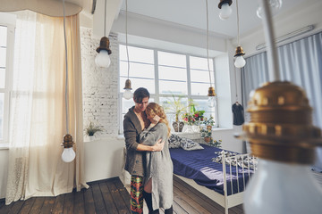 Obraz premium attractive man and woman in the bedroom together cuddling cute