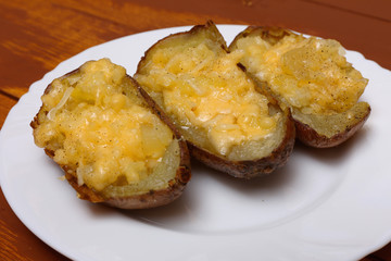 Twice baked potatoes cooked with cream cheese, Parmesan cheese and spices. Rustic style. Popular American dishes.