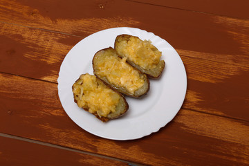 Twice baked potatoes cooked with cream cheese, Parmesan cheese and spices. Rustic style. Popular American dishes.