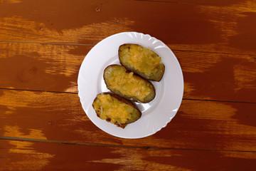 Twice baked potatoes cooked with cream cheese, Parmesan cheese and spices. Rustic style. Popular American dishes.