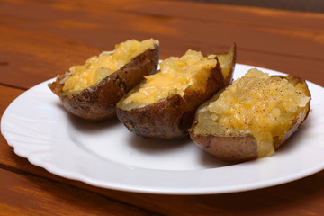 Twice baked potatoes cooked with cream cheese, Parmesan cheese and spices. Rustic style. Popular American dishes.
