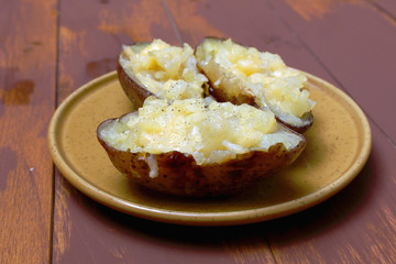 Twice baked potatoes cooked with cream cheese, Parmesan cheese and spices. Rustic style. Popular American dishes.