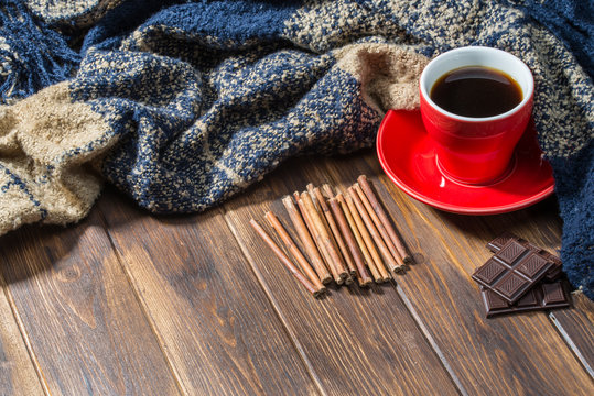 Coffee and blanket on wooden floor