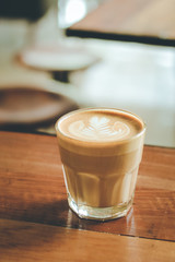 Cup of hot coffee on the table in cafe