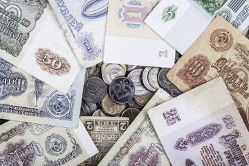 modern coin ruble surrounded by old banknotes of the USSR