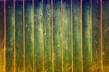 Old wooden fence painted in different colors