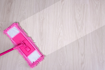 cleaning concept -pink wet mop cleaning wooden floor