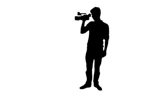 Cameraman silhouette recording video - 1080p. Silhouette of a man holding a video camera and shooting - Full HD