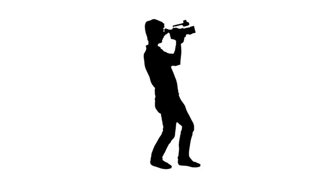 Cameraman silhouette filming - 1080p. Silhouette of a man holding a video camera and shooting - Full HD