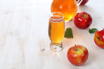 Apple juice and apples on a  wooden table