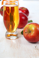 Apple juice and apples on a  wooden table