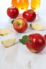 Apple juice and apples on a  wooden table