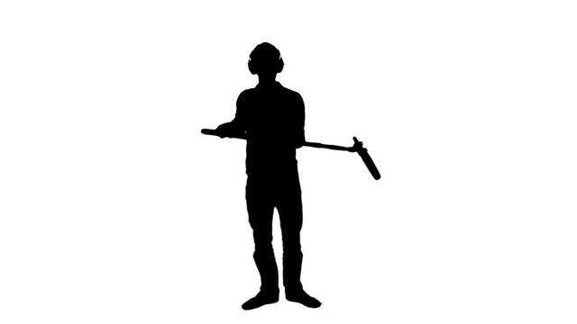 Sound engineer boom microphone silhouette - 1080p. Silhouette of a man holding a boom microphone for a shooting - Full HD