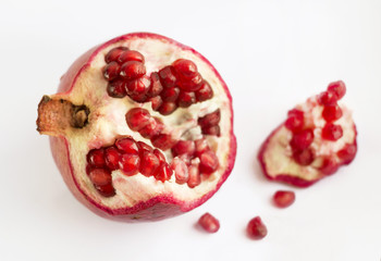 Pomegranate slices and seeds, pomegranate fruit on white background