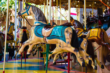 Wooden horses on merry-go-round carousel