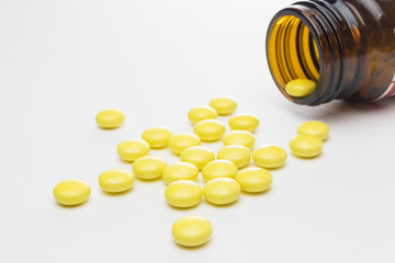 Isolated shot of yellow pharmaceutical drugs - pills