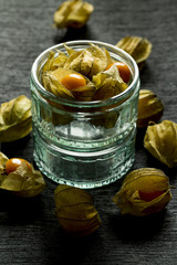 Physalis, tomatillo. Edible fruit, ornamental plant. On white or black background and in a glass bowl. 