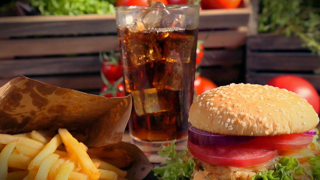 Fresh takeaway hamburger with cold drink and fries
