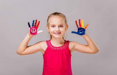 Colorful painted hands in a beautiful young girl.